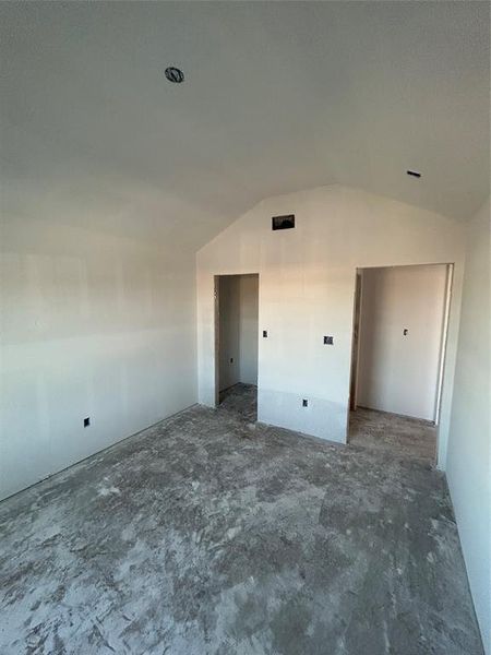 Unfurnished bedroom with lofted ceiling