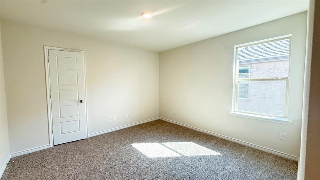 Carpeted empty room with baseboards
