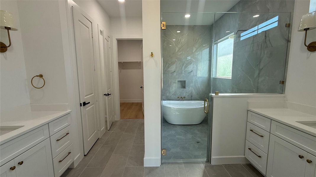 Spa-like oversized shower and freestanding tub.  His and Hers vanities, linen closet, and the bathroom connects to the closet, which connects to the laundry room.
