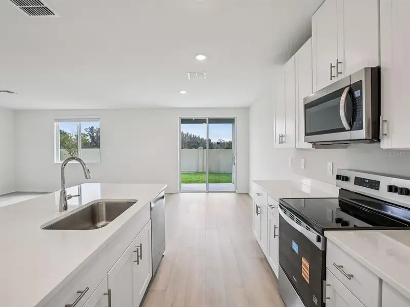 Furnished interior view inside a new home in The Grove at Stuart Crossing - Classic Series, Bartow (Image 9).