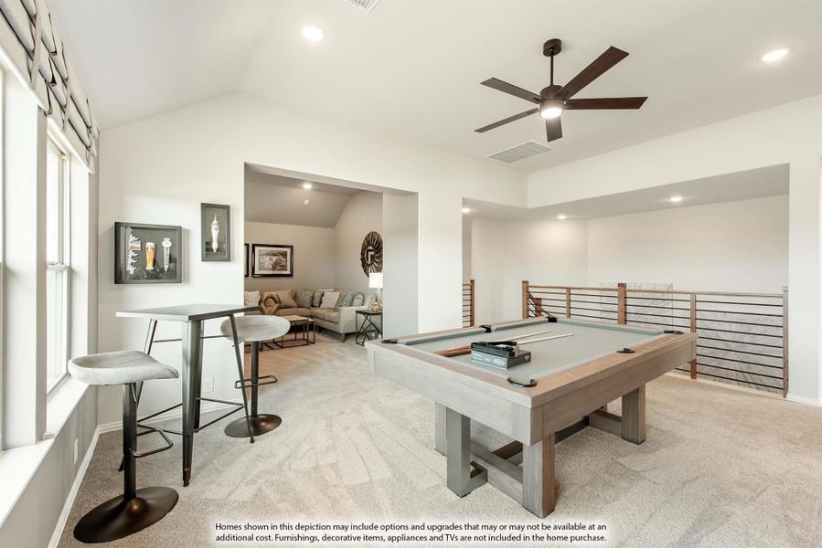 Upstairs game room with pool table, bar-height seating, ceiling fan, and open railing overlooking lower level