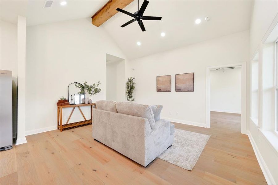 Vaulted ceiling with exposed wood beam and recessed lighting