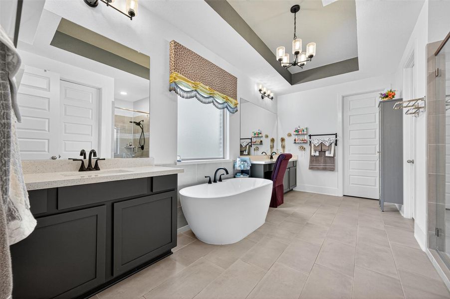 Spacious and elegant bathroom featuring a freestanding tub, dual vanities, and a walk-in shower. The room is brightly lit with modern fixtures and a stylish ceiling design, offering a luxurious and relaxing atmosphere. Spacious and elegant bathroom featuring a freestanding tub, dual vanities, and a walk-in shower. The room is brightly lit with modern fixtures and a stylish ceiling design, offering a luxurious and relaxing atmosphere.