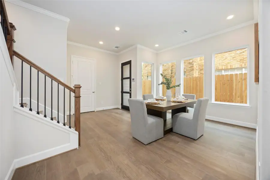 Dine under the soft embrace of daylight, with a wall of windows inviting the outside in.