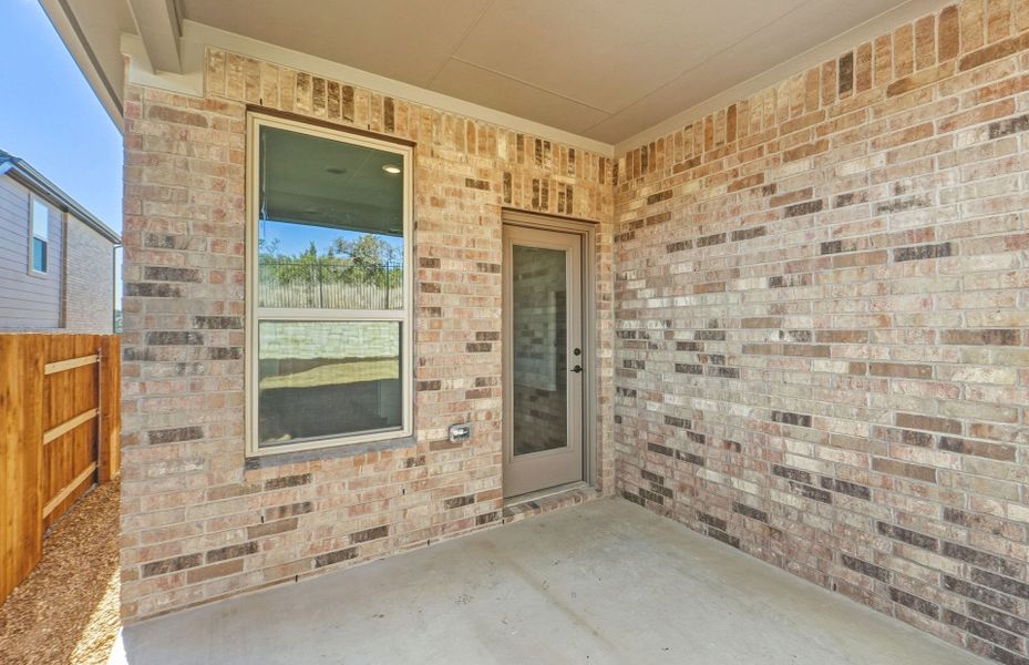 Exterior details and patio area of a home in West Cypress Hills, Spicewood (Image 31).