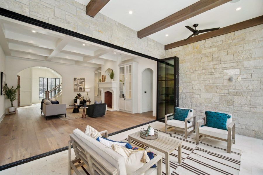 Living room featuring arched walkways, beamed ceiling, recessed lighting, and a ceiling fan