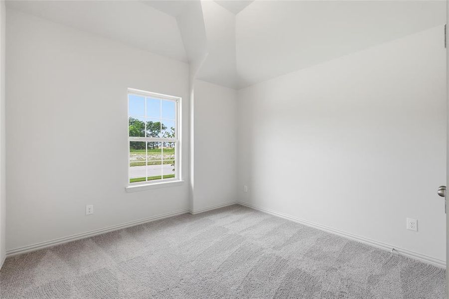 Interior room featuring high vaulted ceilings, light gray carpeting, and white baseboards Interior room featuring high vaulted ceilings, light gray carpeting, and white baseboards