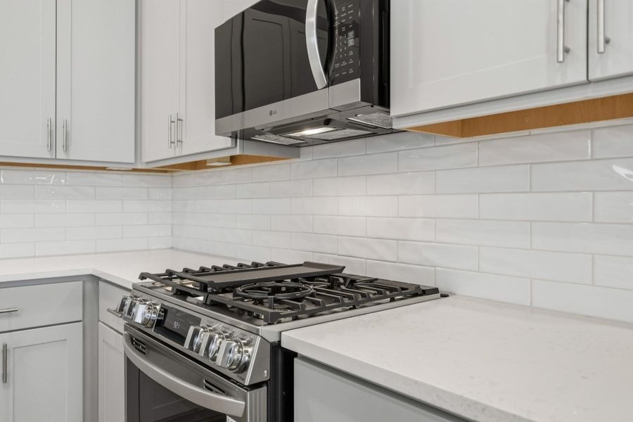 The Heart of the Home—Styled to Shine From the stainless steel undermount sink to the Moen pull-down faucet, every detail here feels elevated. Designer-selected backsplashes add just the right touch of texture and personality.