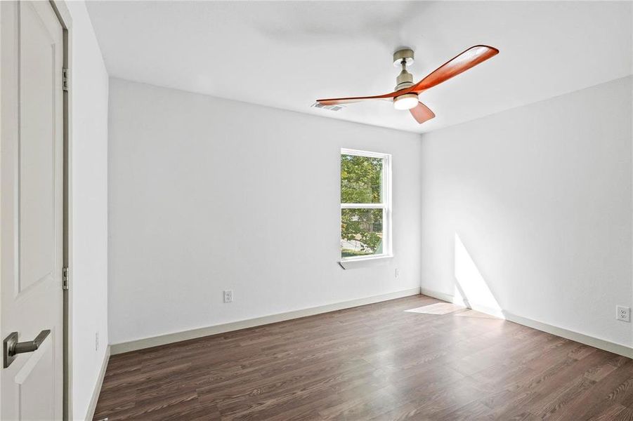 Spare room featuring wood finished floors and ceiling fan
