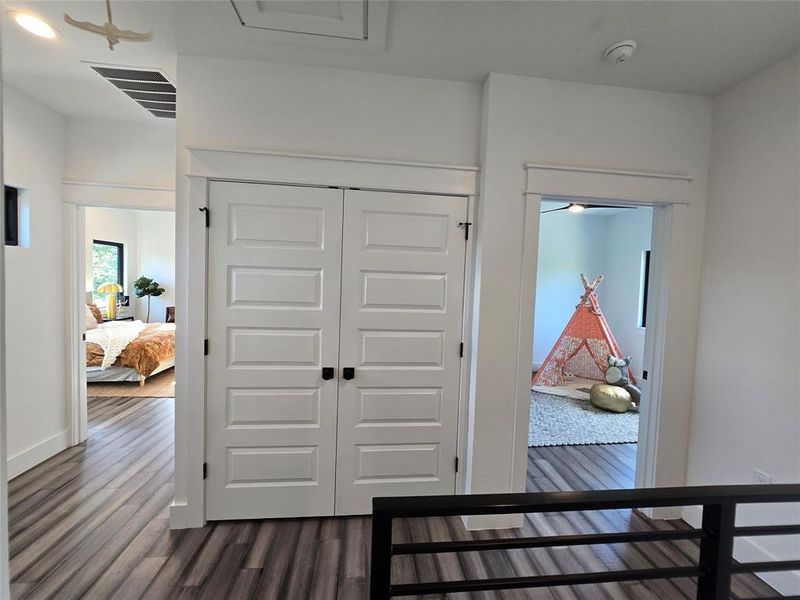 Upstairs overlooking the primary bedroom, laundry, and secondary bedroom entrances.