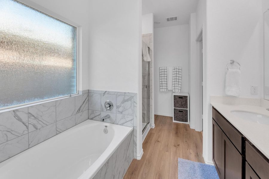 Full bath with visible vents, a bath, vanity, and a stall shower