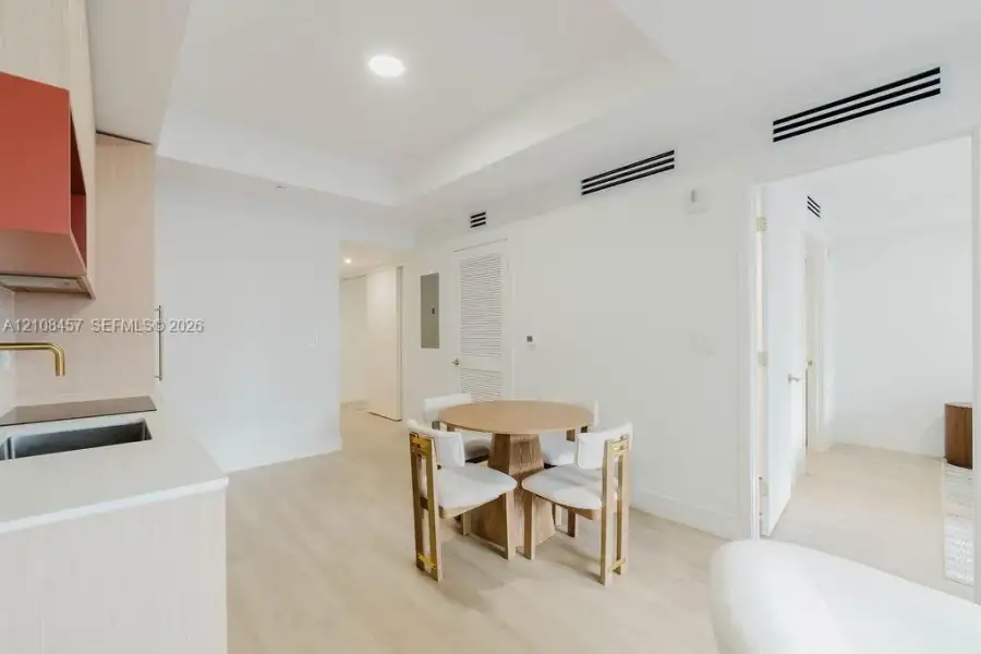 Light wood-finish flooring, recessed lighting, matte-finish solid surface countertops, metallic-finish faucet, and clean-lined cabinetry Light wood-finish flooring, recessed lighting, matte-finish solid surface countertops, metallic-finish faucet, and clean-lined cabinetry