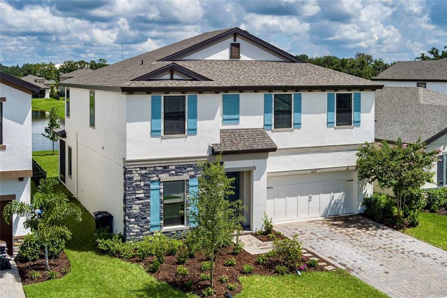 Front exterior of a new home in Crosswind Point, Parrish, FL, highlighting curb appeal (Image 25).