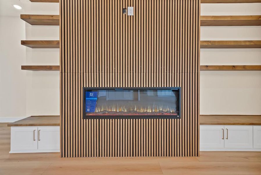 Detailed view of wood finished floors and a glass covered fireplace Detailed view of wood finished floors and a glass covered fireplace