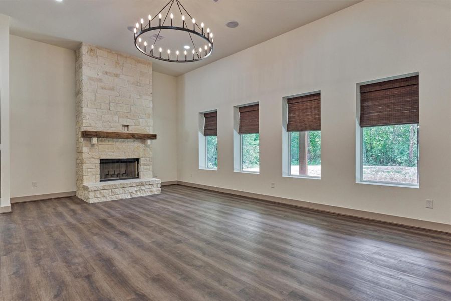 The stunning floor-to-ceiling wood burning stone fireplace serves as the focal point of the expansive living area and adds warmth and character to the space