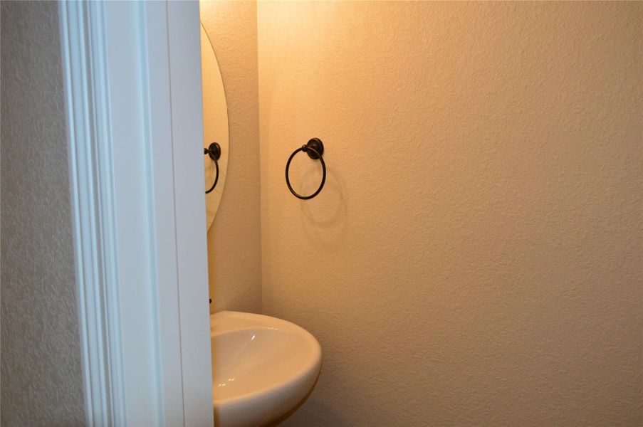 Bathroom with a textured wall and a sink