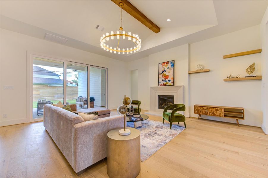 Elegant living room centered around a modern fireplace with expansive glass doors that create a seamless indoor-outdoor connection.