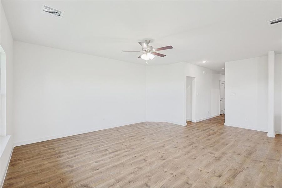 Empty room featuring ceiling fan and light hardwood / wood-style flooring