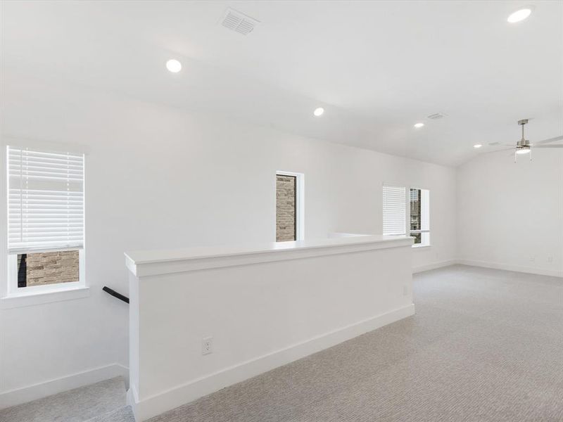 Game room featuring light colored carpet, recessed lighting, a ceiling fan, and lofted ceiling