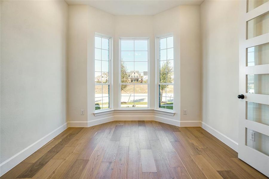 Spare room with light wood-type flooring and baseboards
