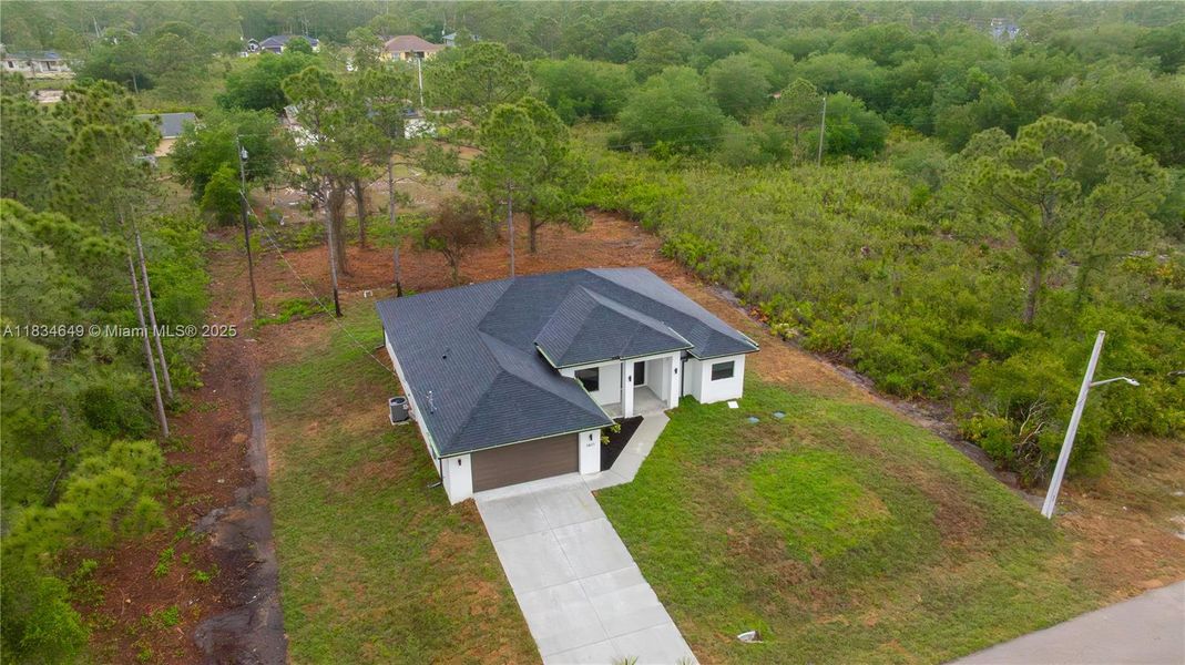 Front exterior of a new home in , Lehigh Acres, FL, highlighting curb appeal (Image 25).