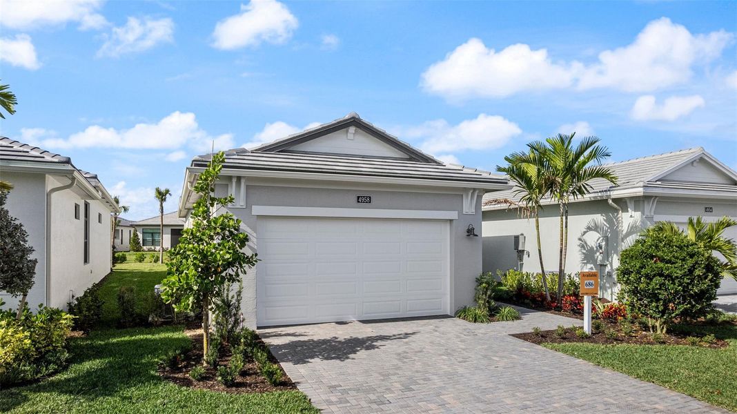 Front exterior of a new home in Cresswind Palm Beach at Westlake, Westlake, FL, highlighting curb appeal (Image 1). Front exterior of a new home in Cresswind Palm Beach at Westlake, Westlake, FL, highlighting curb appeal (Image 1).
