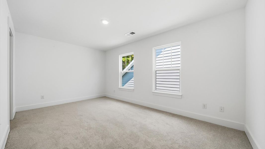 Superior comfort in this light-filled bedroom with plush carpeting and thoughtfully placed large windows Superior comfort in this light-filled bedroom with plush carpeting and thoughtfully placed large windows
