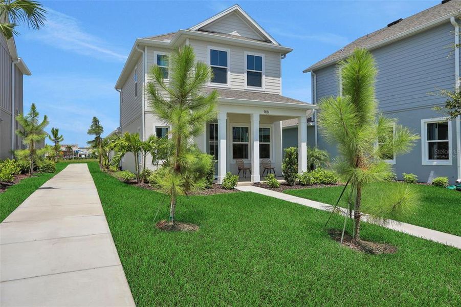 Front exterior of a new home in Bungalow Walk at Lakewood Ranch, Sarasota, FL, highlighting curb appeal (Image 21).