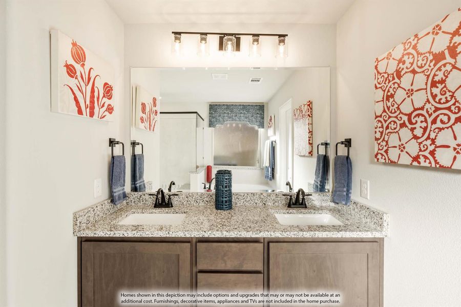 Bathroom with double sink vanity, granite countertop, wood cabinets, and large mirror with overhead lighting Bathroom with double sink vanity, granite countertop, wood cabinets, and large mirror with overhead lighting