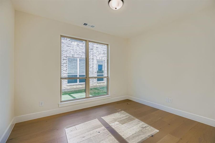 Empty room with baseboards and wood finished floors