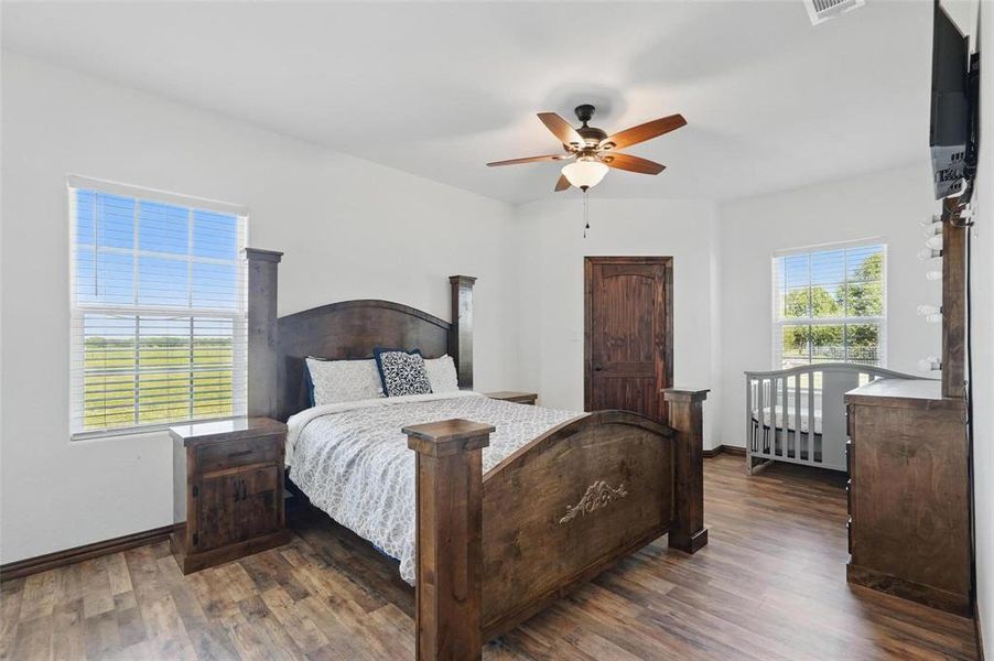 Bedroom featuring wood finished floors and a ceiling fan Bedroom featuring wood finished floors and a ceiling fan