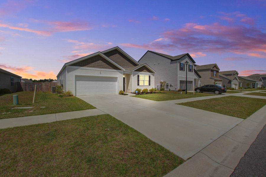 Front exterior of a new home in Pine Hills at Cane Bay, Summerville, SC, highlighting curb appeal (Image 23).