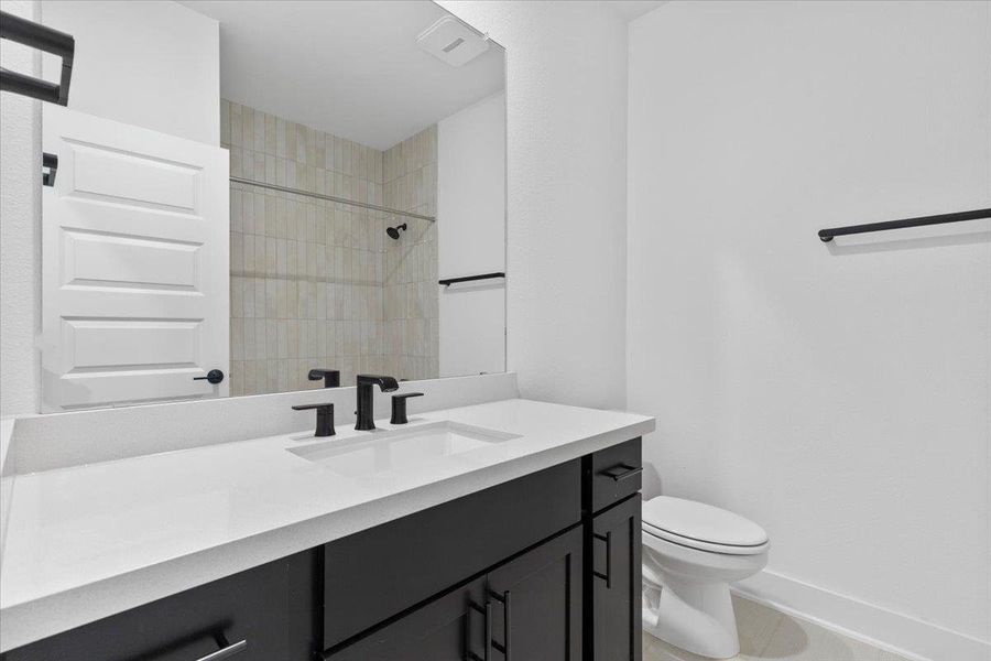 Bathroom featuring vanity and a tile shower