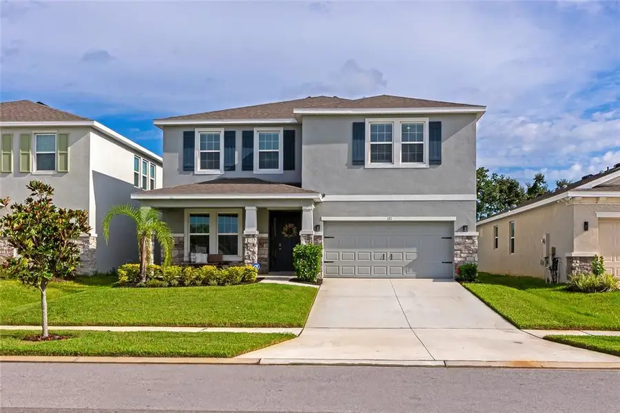 Front exterior of a new home in , Apollo Beach, FL, highlighting curb appeal (Image 23).