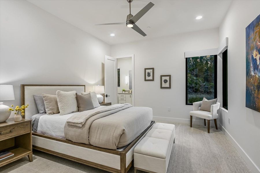 Bedroom featuring light carpet, ceiling fan, recessed lighting, and ensuite bath Bedroom featuring light carpet, ceiling fan, recessed lighting, and ensuite bath