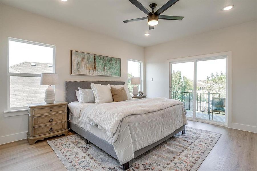 The primary bedroom is upgraded with luxury vinyl plank flooring and complete with a balcony.