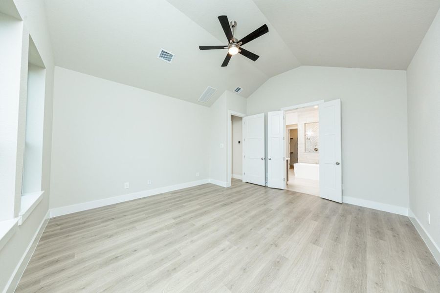 Additional view from primary bedroom looking towards the double door entrance to primary bathroom.