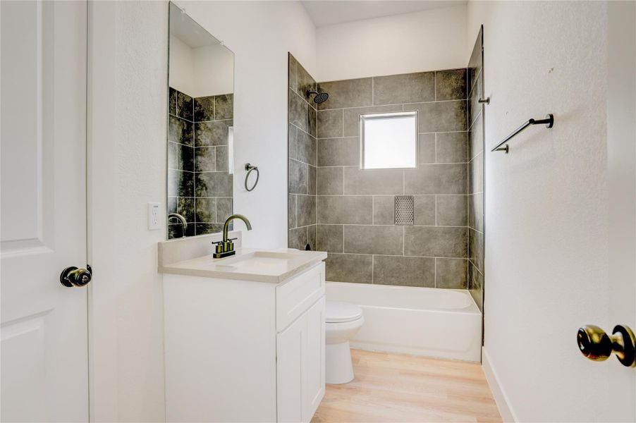 Secondary bedroom downstairs includes a full en suite bathroom.