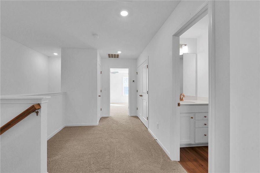 This bright hallway connects to a bathroom featuri This bright hallway connects to a bathroom featuri