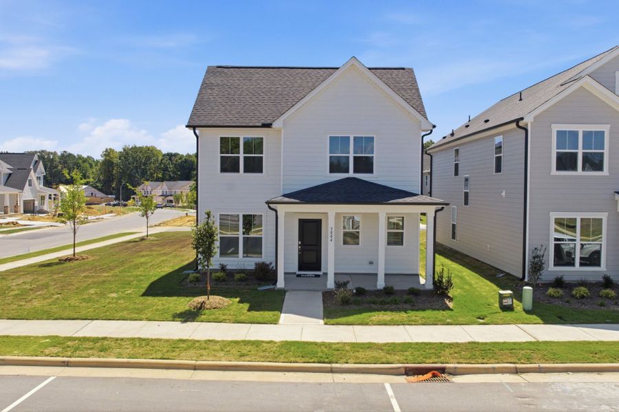 Front exterior of a new home in Saunders Farm, Willow Spring, NC, highlighting curb appeal (Image 2). Front exterior of a new home in Saunders Farm, Willow Spring, NC, highlighting curb appeal (Image 2).