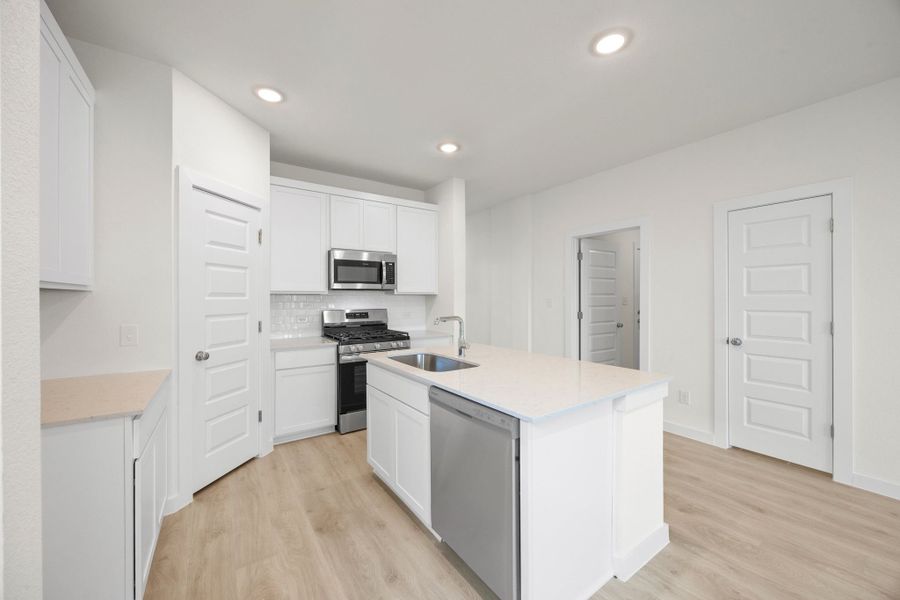 Kitchen in the Pearl home plan by Trophy Signature Homes – REPRESENTATIVE PHOTO