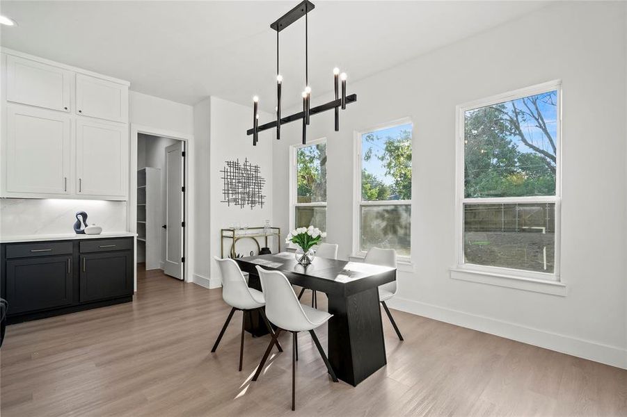 Dining space featuring light wood-style floors and a chandelier