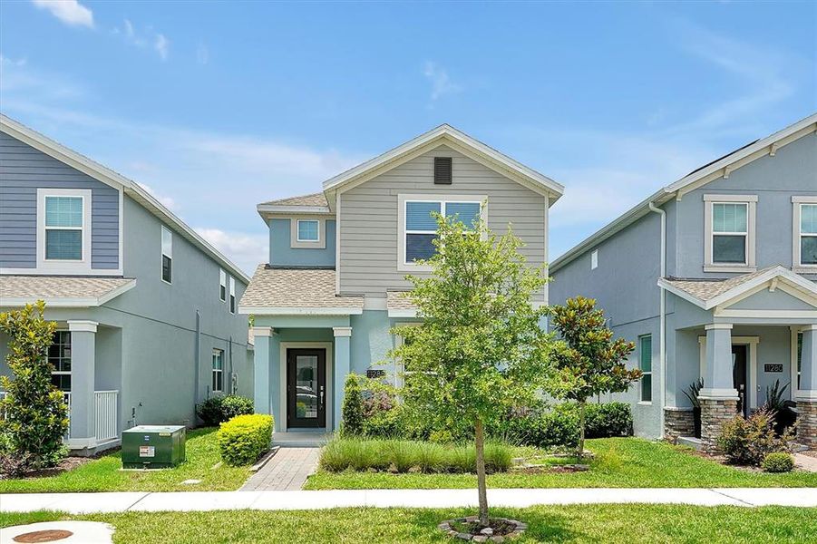 Front exterior of a new home in , Orlando, FL, highlighting curb appeal (Image 1).