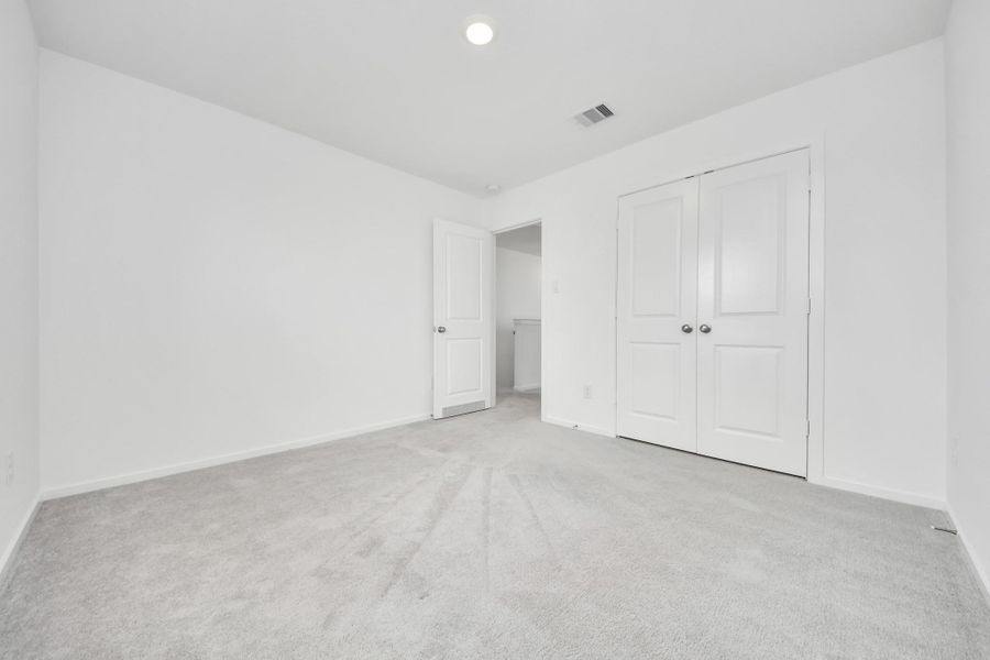 Spacious secondary bedroom with a bright and inviting feel.