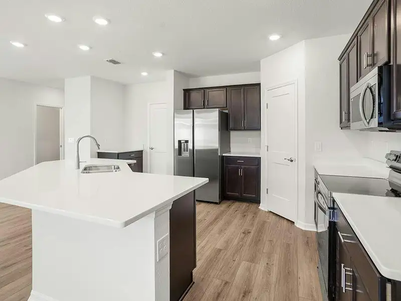 Your beautiful kitchen includes quartz, 36-inch cabinets, Samsung SS appliances, and a walk-in pantry.