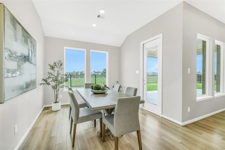 Dining space featuring view of the lake and direct access to the extended travertine rear patio.
