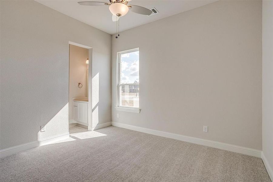 Spare room with ceiling fan and light colored carpet