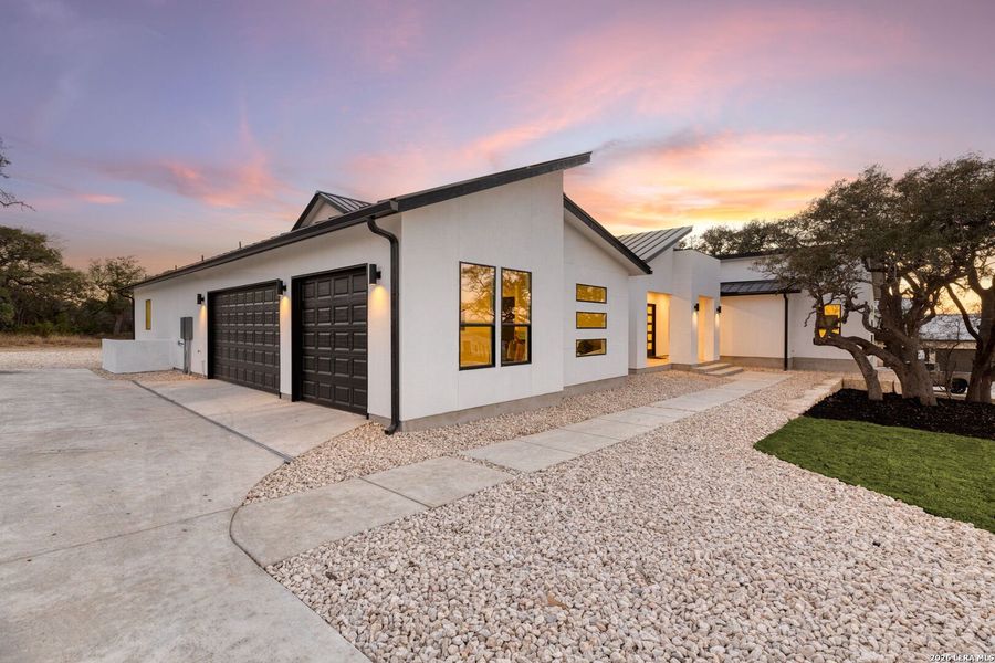 Front exterior of a new home in , Bulverde, TX, highlighting curb appeal (Image 24).