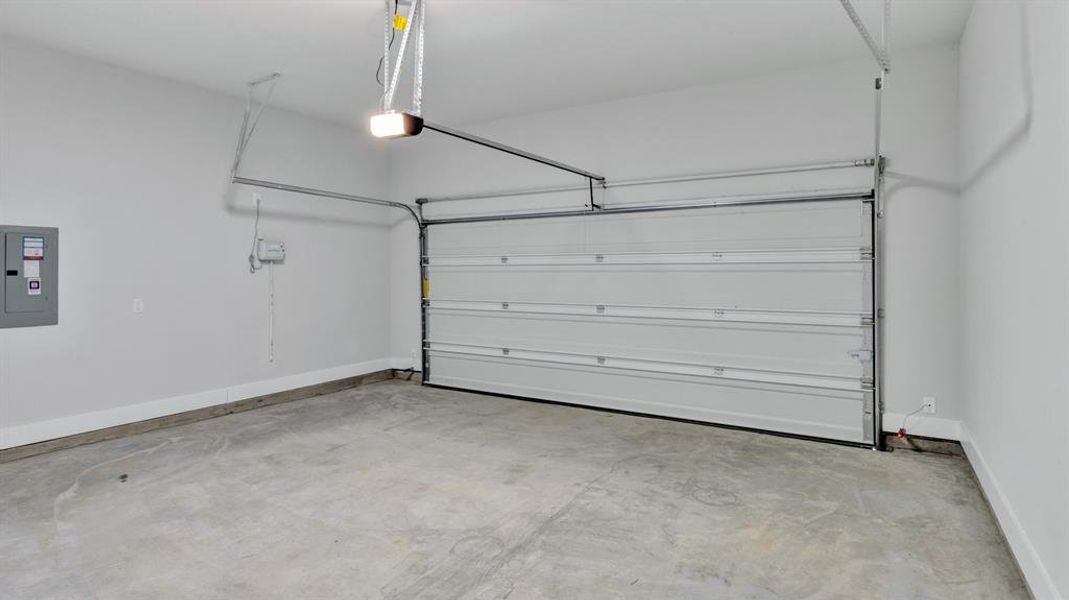 Garage with electric panel and a garage door opener