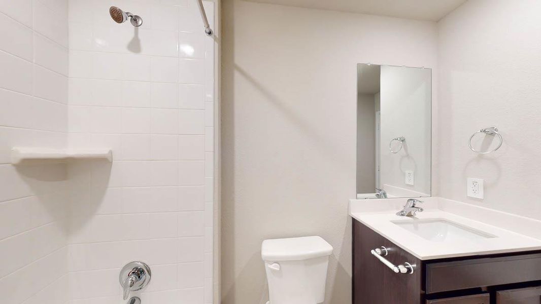 A well-appointed bathroom offers a clean shower and modern vanity. A well-appointed bathroom offers a clean shower and modern vanity.